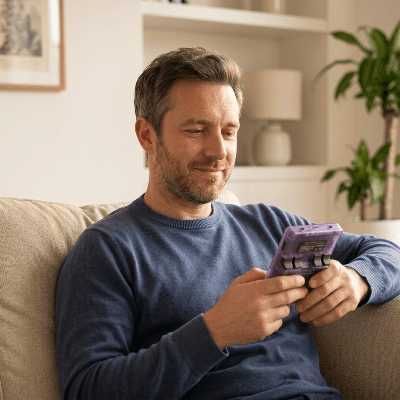 Person playing the Tikveotr Pro 2.0 R36S retro gaming console at home